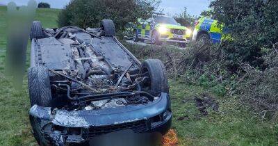 Driver climbs out of overturned car and runs away after Audi flips onto roof during police chase