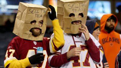 Commanders fans wear paper bags saying 'Sell The Team' amid owner Dan Snyder's NFL drama