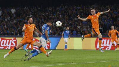 Soccer-Napoli ease to victory over Rangers and make club history