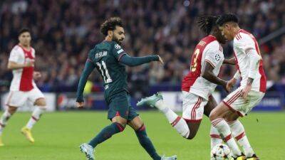 Soccer-Liverpool ensure Champions League progress with win at Ajax