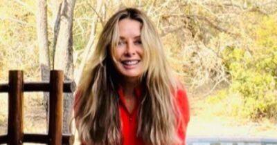 Carol Vorderman gives 'middle finger' as she claps back at being told about 'acting her age' in fiery red gym gear display