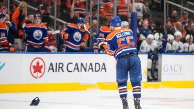 Holloway's four points lead Oilers to rout of Canucks