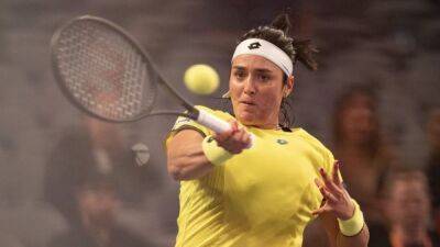 Tennis-Jabeur battles back to beat Pegula at WTA Finals