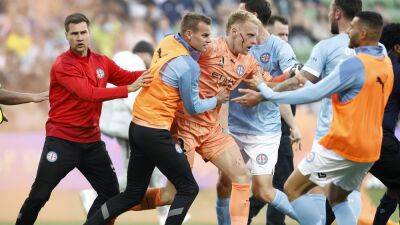 A-League derby abandoned after fans invade pitch and attack Melbourne City goalkeeper Tom Glover