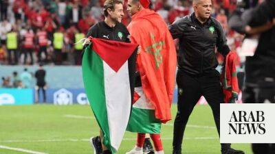 Morocco players celebrate with Palestinian flag after Spain upset