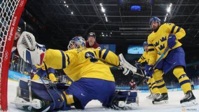 Ice hockey-Sweden survive Latvia fightback to secure win