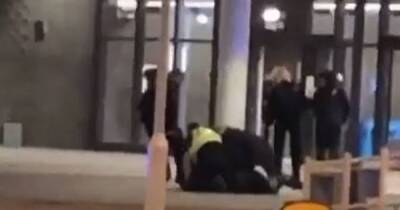 Police officer filmed 'kicking boy in head like football' in melee outside bus station
