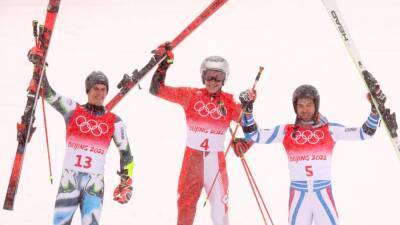 Marco Odermatt claims giant slalom gold at Winter Olympics as blizzard causes havoc in Beijing