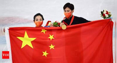 Winter Olympics: Chinese pair banish fraught Games with home gold