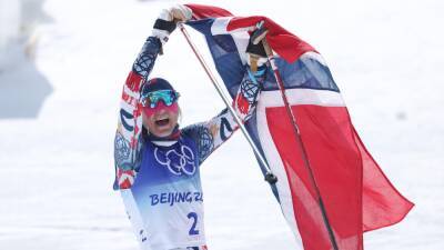Winter Olympics 2022 - Therese Johaug overcomes wild weather to emerge with gold in brutal women's 30km mass start