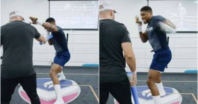 Anthony Joshua shares training footage with Fury v Wilder on a big screen in the background