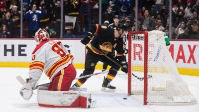 Miller puts up four points, Canucks snap Flames' 10-game win streak