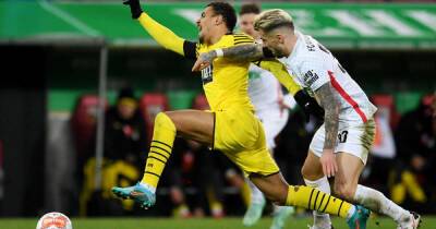 Soccer-Dortmund suffer blow in title race with scrappy draw at Augsburg