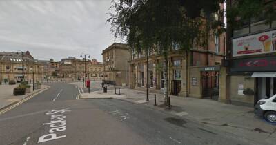 Man charged with racially aggravated assault after 3am town centre attack - a man is fighting for his life