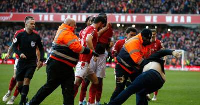 Man arrested after Nottingham Forest players attacked by pitch invader