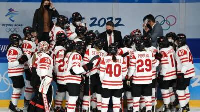 Ice hockey-Canada beat Russians in chaotic delayed game wearing masks