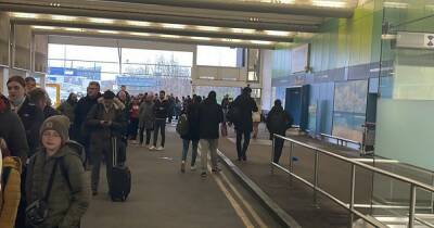 Manchester Airport apologises over passenger queues so long they end in the car park