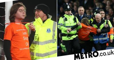 Protestor ties himself to Everton goalpost by his neck and is attacked by a fan - metro.co.uk