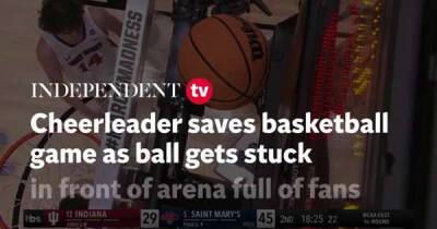 Cheerleader saves basketball game in the most creative way after ball gets stuck
