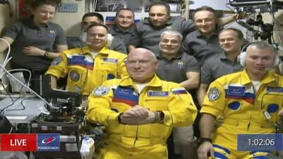 Russian cosmonauts on International Space Station mission arrive wearing Ukraine yellow and blue