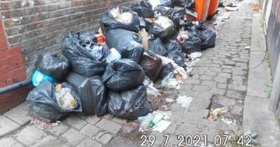 Two south Manchester takeaways slapped with £20,000 fine for dumping piles of rubbish in alleyway