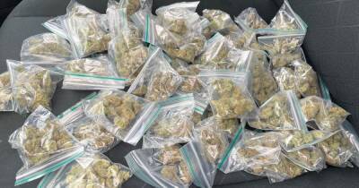 Multiple bags of 'drugs' cash and a car seized by police