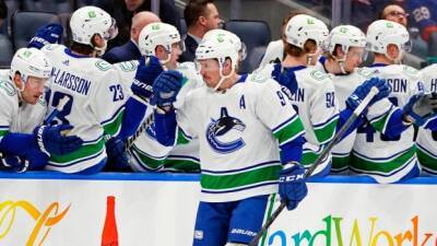 Canucks score twice early in third, rally past Islanders