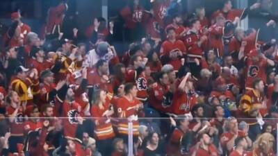 Many unmasked hockey fans jam into Saddledome as restrictions drop - cbc.ca