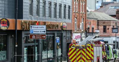 Four people rescued and town centre road closed as firefighters battle restaurant blaze