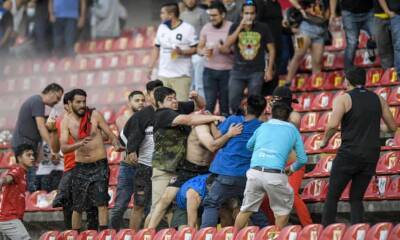 Liga MX suspended after dozens injured as fans fight on pitch at Queretaro v Atlas
