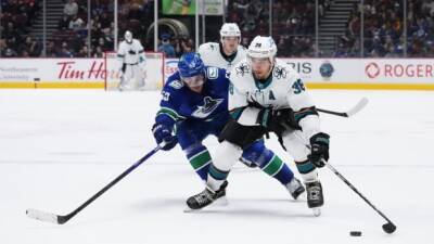 Canucks double up Sharks to stay in playoff hunt