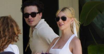 Newlywed Brooklyn Beckham can't keep his hands off bride Nicola Peltz as they're seen for the first time after lavish wedding