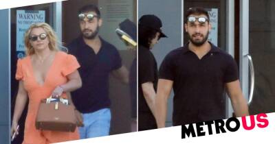 Pregnant Britney Spears hides stomach with bag as she’s snapped with Sam Asghari before baby announcement