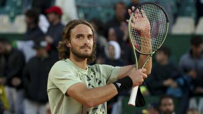 Defending champion Stefanos Tsitsipas edges into the Monte-Carlo Masters last eight but Casper Ruud bows out early