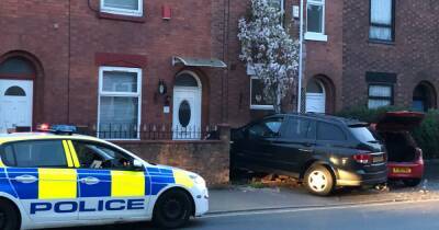 LIVE: Road closed after two cars smash into home