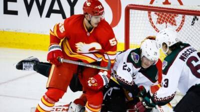 Flames secure playoff berth, then score 9 unanswered goals to breeze past Coyotes