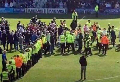 Gillingham and Rotherham United fans clash on the pitch at Priestfield following their League 1 match