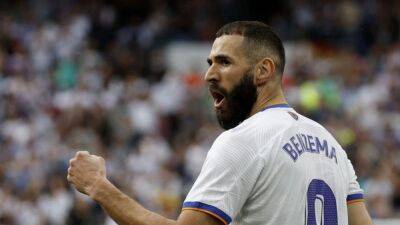 Brilliant Benzema guides Real Madrid to league title