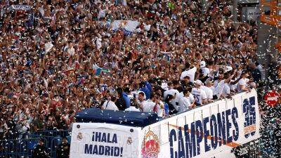 Real Madrid celebrate La Liga title with bus parade as thousands of fans pack the streets
