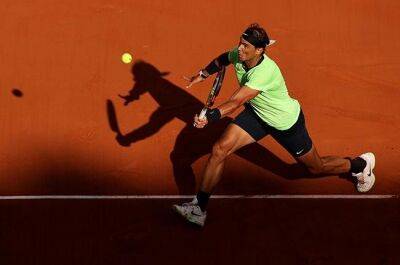 Nadal tests injury in front of packed French Open stands