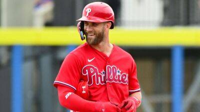 Philadelphia Phillies star Bryce Harper trades hats with a fan