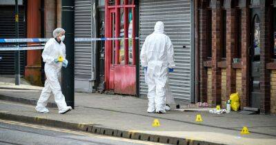 Busy street becomes crime scene as one man loses life and another is questioned by murder squad detectives