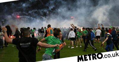 Saint-Etienne fans launch violent pitch invasion and attacks as team relegated from Ligue 1