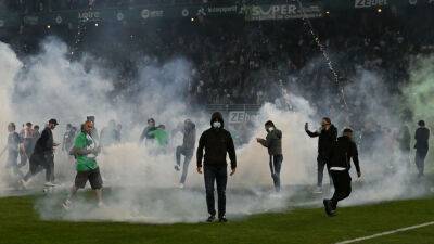 Riot police clash with pitch-invading fans as Saint-Étienne relegated from Ligue 1