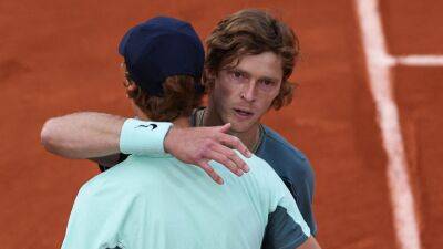 Andrey Rublev reaches French Open quarter-finals after Jannik Sinner retires with knee injury