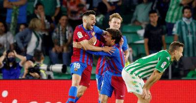 Soccer-Barca secure Champions League spot with 2-1 Betis win