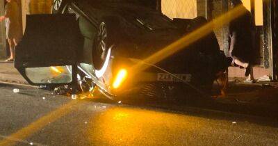 Driver flees after car smashes into lamppost and flips in early hours