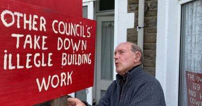 Pensioner drills holes into neighbour's wall because he claims it is two inches into his garden - manchestereveningnews.co.uk