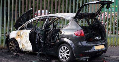Hunt for balaclava-clad arsonists who torched car moments after rush hour crash