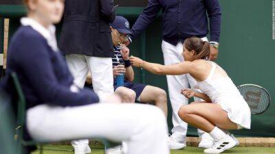 Lesia Tsurenko - Jodie Burrage - Britain's Jodie Burrage comes to the aid of unwell ball boy with sweets during first round Wimbledon match - edition.cnn.com - Britain - Ukraine
